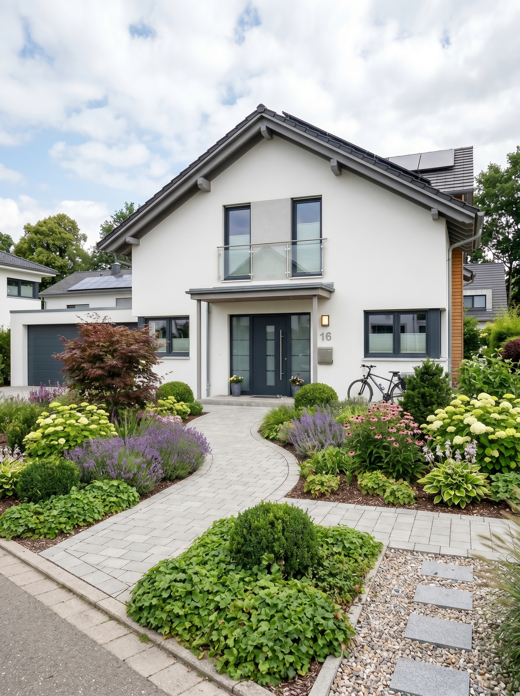 Idyllischer Vorgarten in Stuttgart mit hochwertiger Bepflanzung, blühenden Pflanzen und moderner Gartengestaltung vom Galabau-Profi